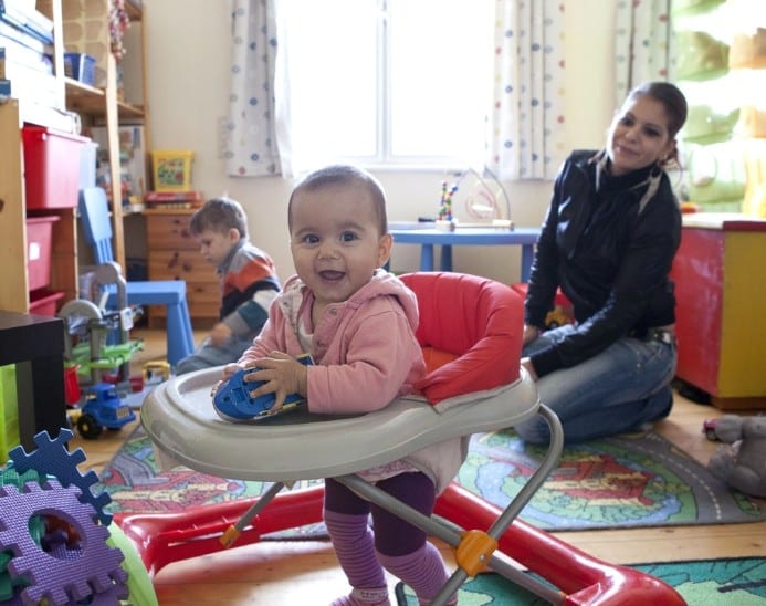 Two children and a woman in a room